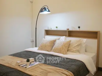Cozy bedroom with stylish decor and modern lighting