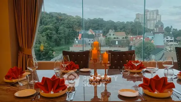 Elegant dining room with panoramic view of lush greenery and cityscape.