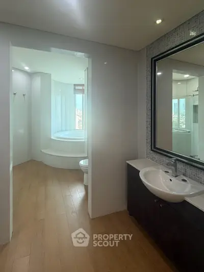 Luxurious bathroom with modern fixtures and spacious bathtub, perfect for relaxation.