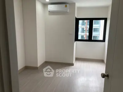 Spacious empty room with air conditioning and large window in modern apartment.