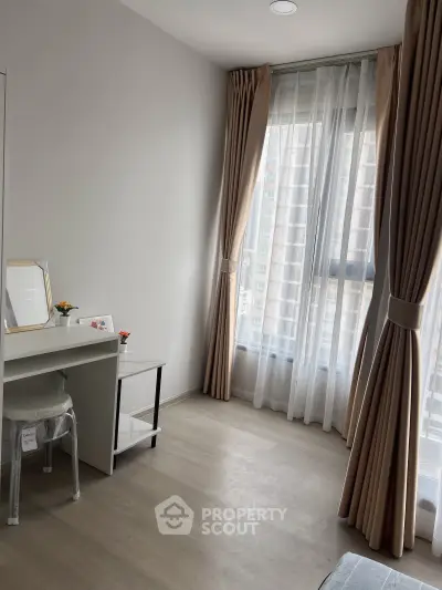 Bright and airy bedroom with floor-to-ceiling windows and elegant curtains, perfect for a serene living space.