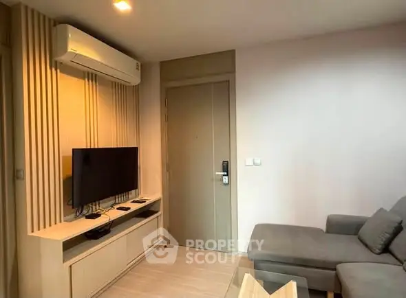 Modern living room with sleek furniture and wall-mounted TV, perfect for cozy relaxation.