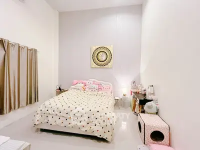 Cozy bedroom with modern decor and soft lighting, featuring a comfortable bed and stylish furnishings.