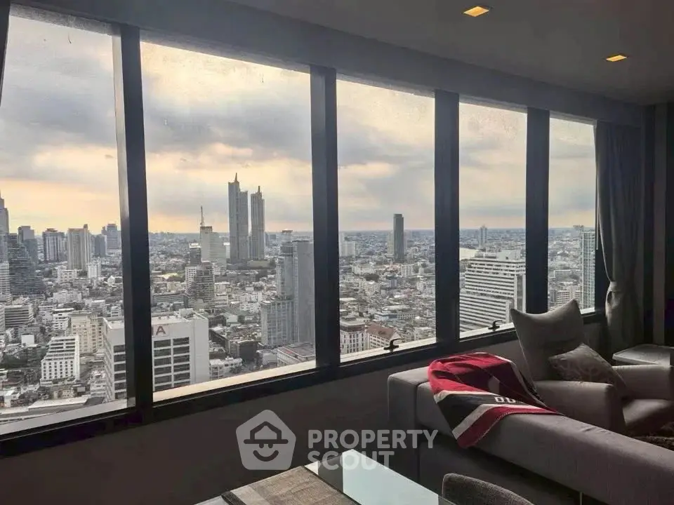 Stunning cityscape view from a modern high-rise apartment living room with large windows.