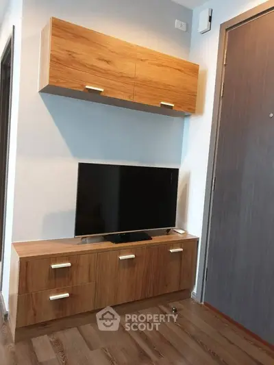 Modern living room with sleek wooden TV cabinet and mounted storage