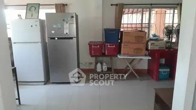 Spacious kitchen area with modern appliances and ample storage space.