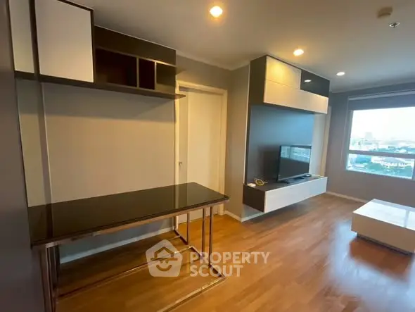 Modern living room with sleek furniture and city view, perfect for urban living.