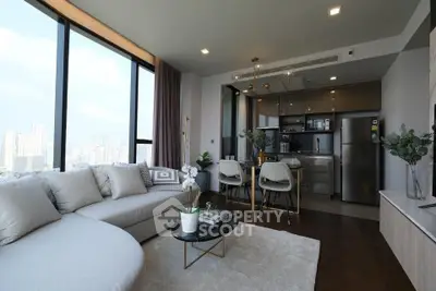 Luxurious modern living room with panoramic city view and open kitchen layout.