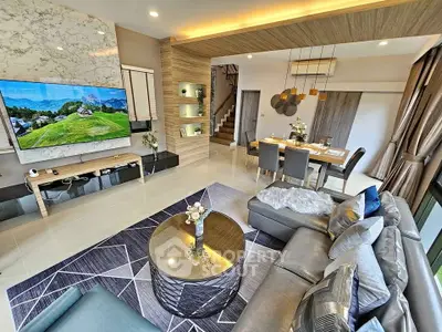 Luxurious modern living room with stylish decor and open dining area, perfect for entertaining.