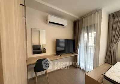 Modern bedroom with sleek design, featuring a wall-mounted TV, air conditioning, and elegant curtains.