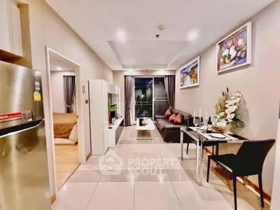 Modern living room with dining area and stylish decor in a cozy apartment.