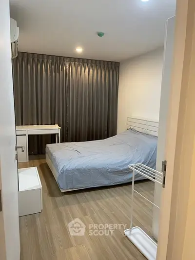 Cozy bedroom with modern furnishings and wooden flooring