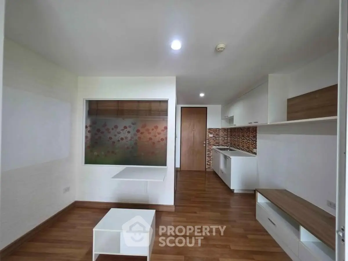Modern living room with open kitchen and stylish wooden flooring