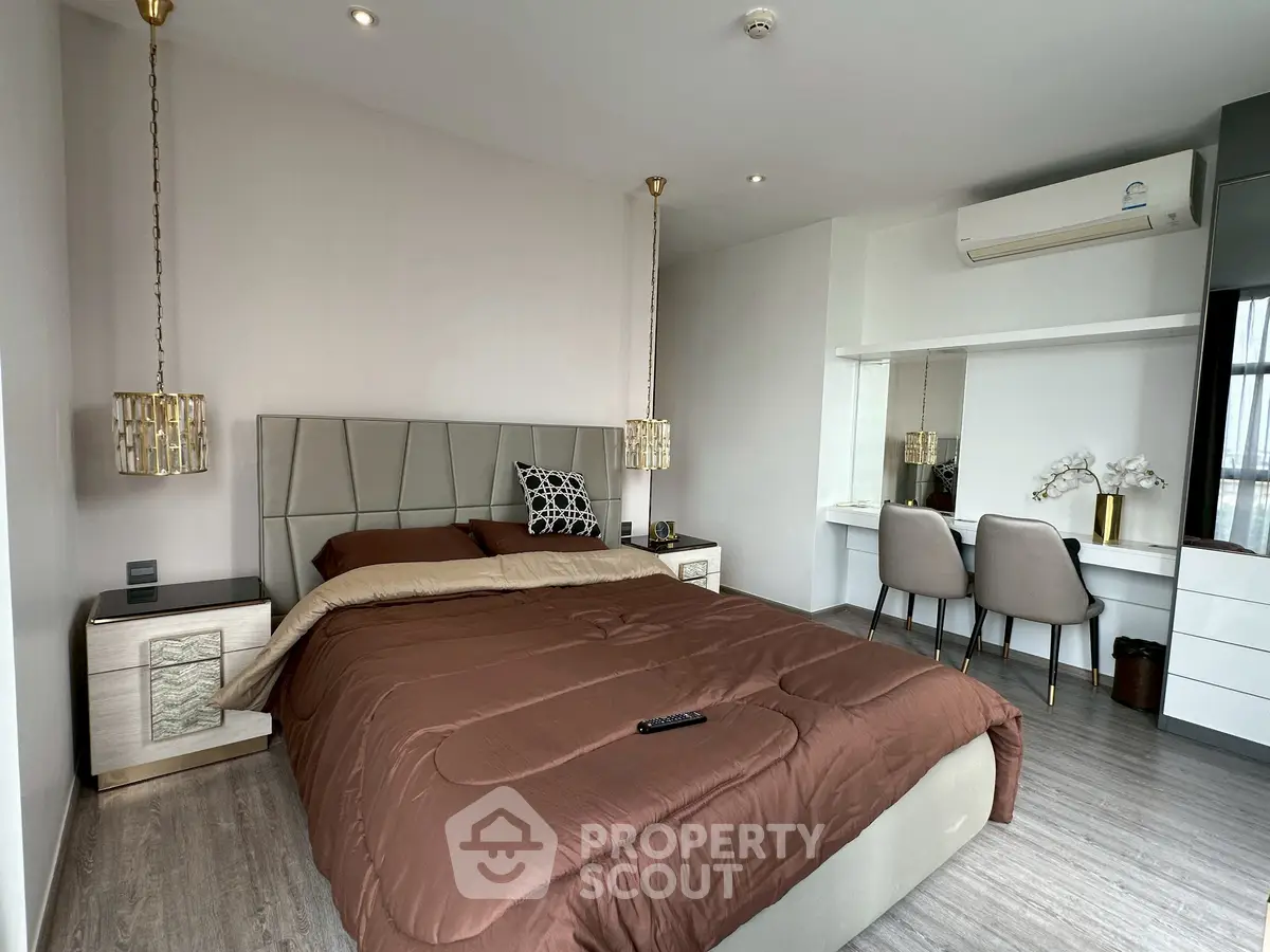 Luxurious bedroom with modern decor, featuring a plush bed and stylish workspace.