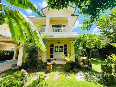 Charming two-story house with lush garden and tropical plants