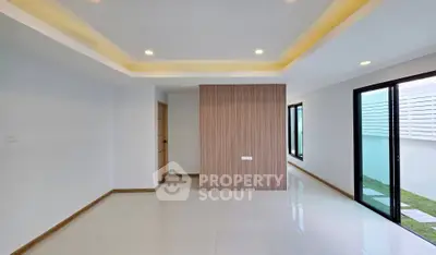 Modern minimalist interior with recessed lighting and large windows in a spacious living area.