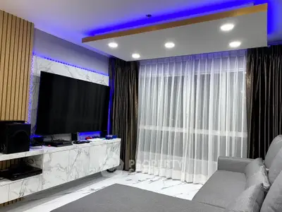 Modern living room with stylish marble accents and ambient lighting