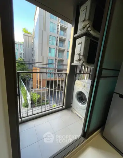 Modern apartment balcony with washing machine and city view