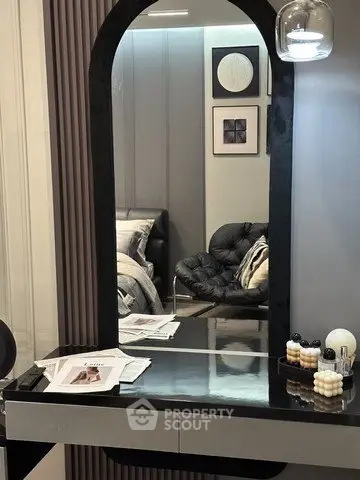 Stylish modern bedroom with elegant vanity and cozy seating area, perfect for relaxation and comfort.