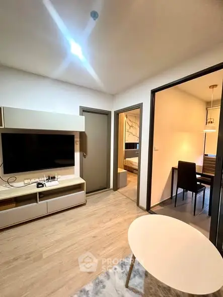 Modern apartment interior with cozy living room and dining area, featuring stylish furniture and warm lighting.