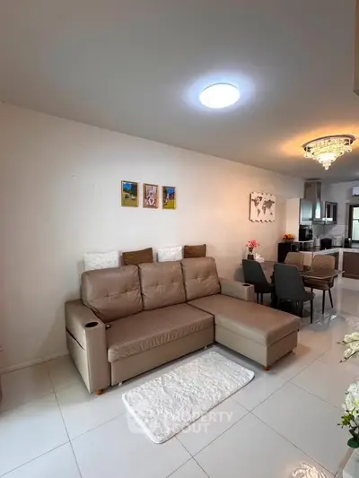 Modern living room with elegant sofa and dining area in open layout apartment