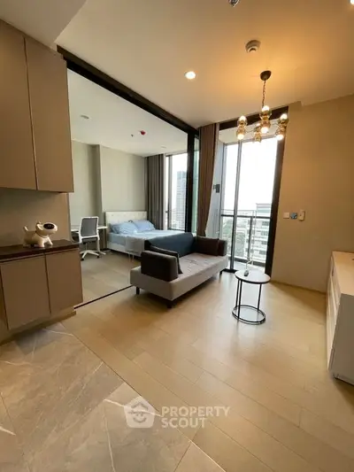 Modern open-plan living room with stylish decor and city view balcony