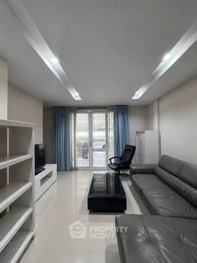 Spacious modern living room with sleek furniture and natural light