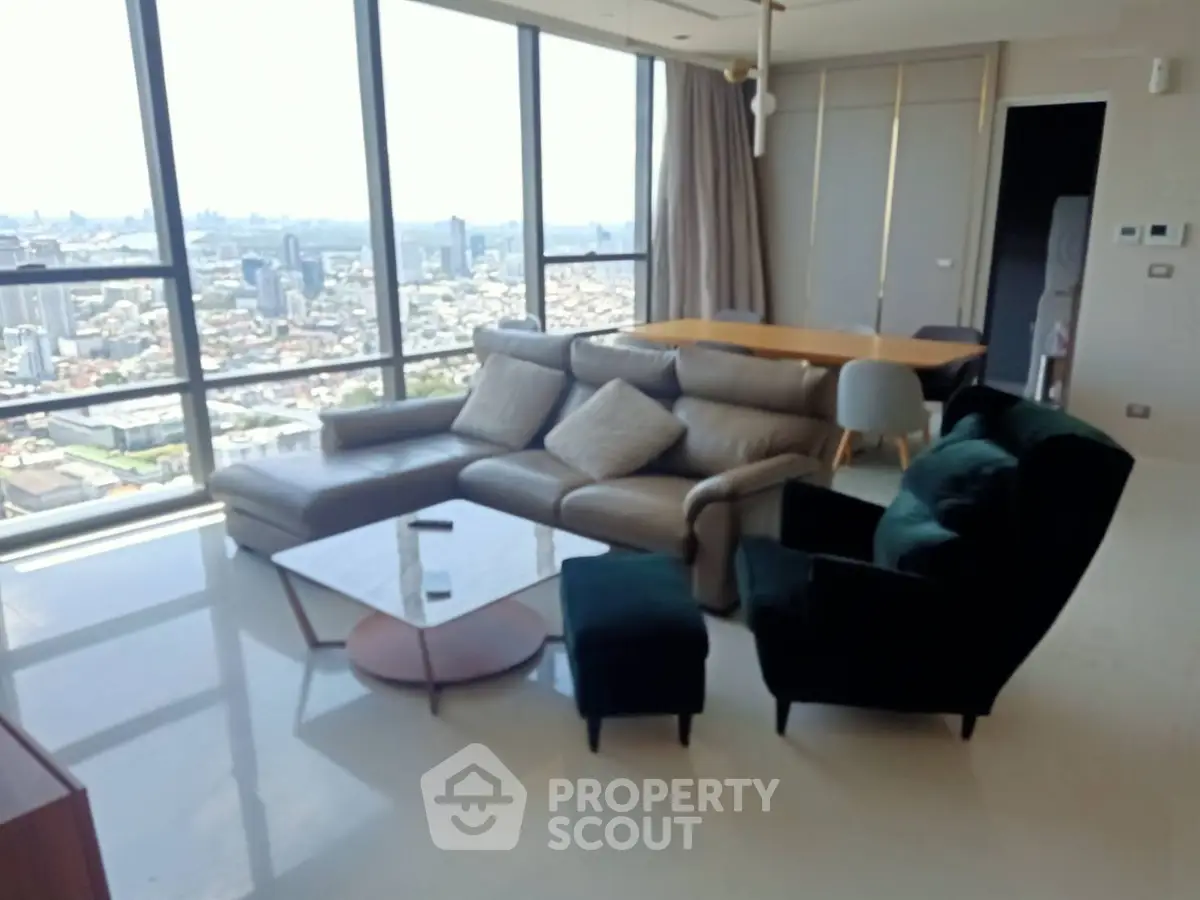 Luxurious high-rise living room with panoramic city views and modern furniture.