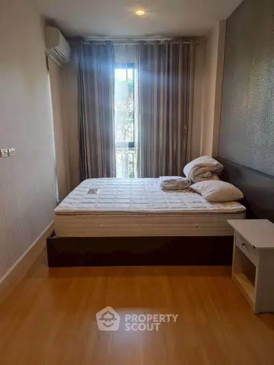 Cozy bedroom with natural light and modern decor, featuring a comfortable bed and stylish curtains.