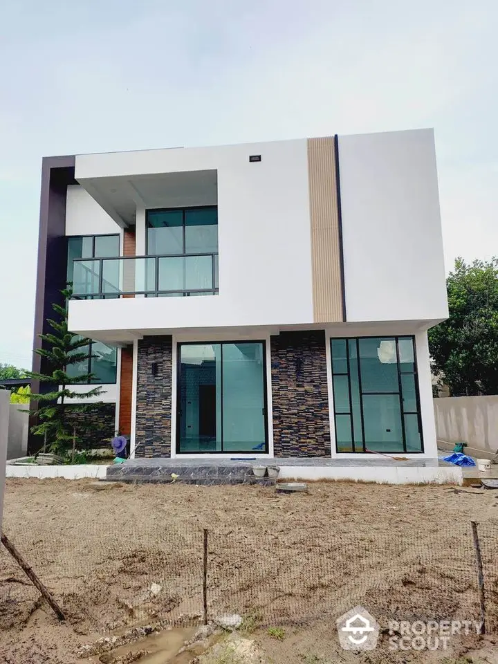 Modern two-story house with large windows and contemporary design