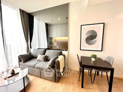 Modern living room with stylish decor, large windows, and cozy seating area in a contemporary apartment.
