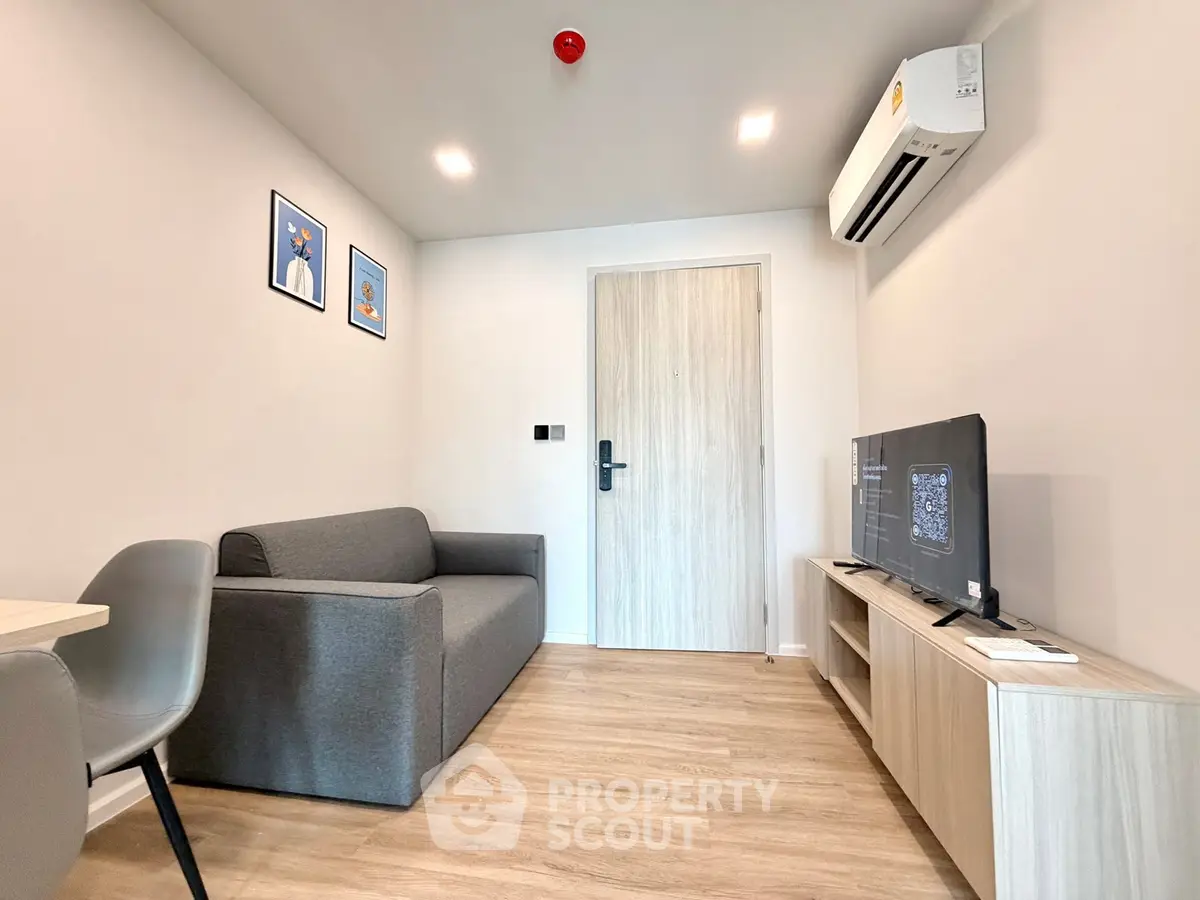 Modern living room with sleek furniture and air conditioning in a stylish apartment.