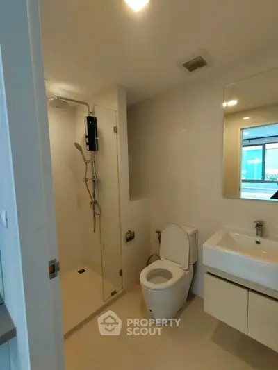 Modern bathroom with glass shower and sleek fixtures