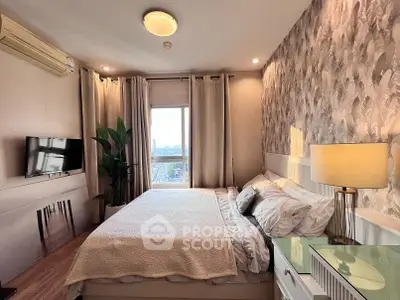 Cozy bedroom with stylish wallpaper and city view, featuring a comfortable bed and modern decor.