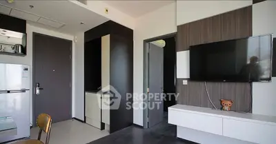 Modern living room with sleek TV setup and stylish furniture in a contemporary apartment.