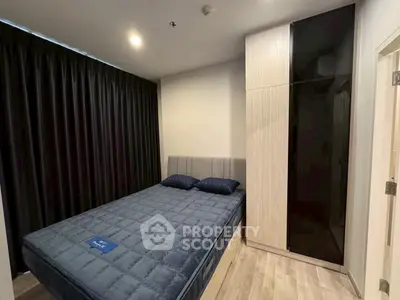 Modern bedroom with sleek design, featuring a cozy bed and stylish wardrobe.