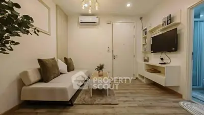 Chic modern living room with cozy sofa, wall-mounted TV, and elegant decor in a stylish apartment.