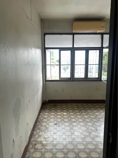 Spacious room with large windows and vintage tiled flooring, perfect for customization.