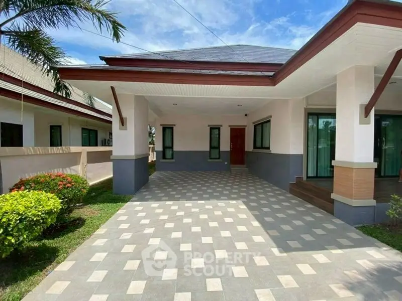 Charming single-story home with spacious driveway and lush garden, perfect for family living.