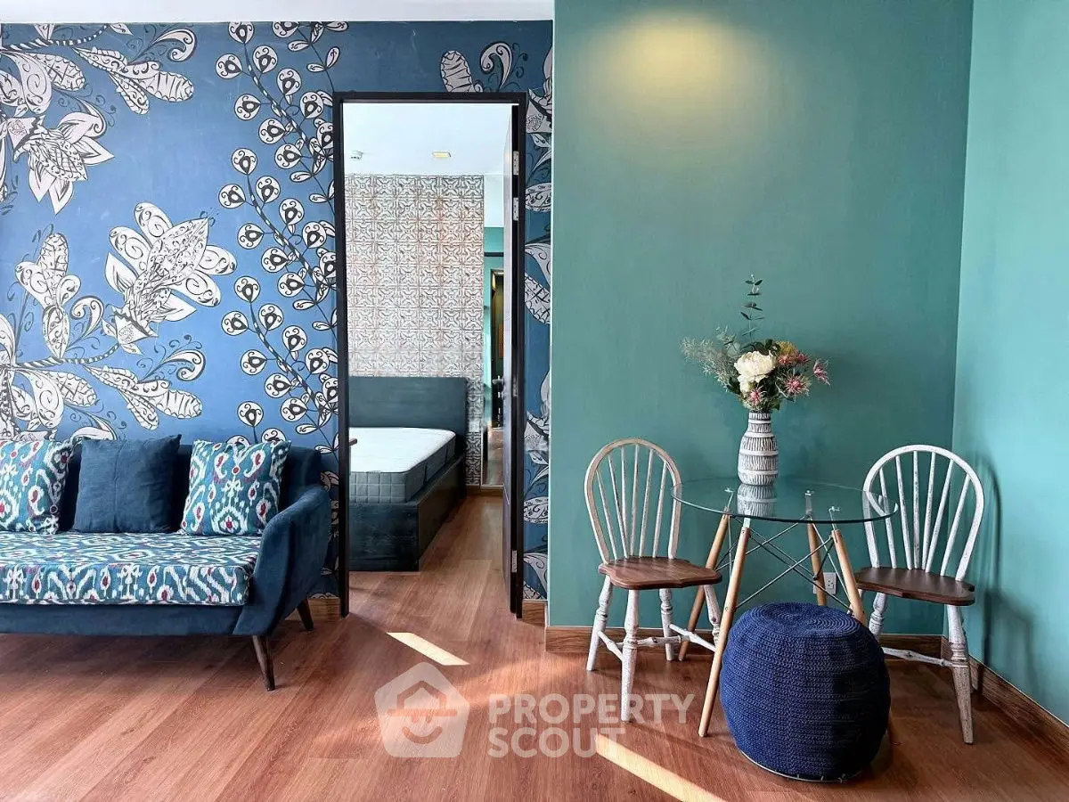 Chic living room with stylish decor and vibrant wallpaper, perfect for modern living.