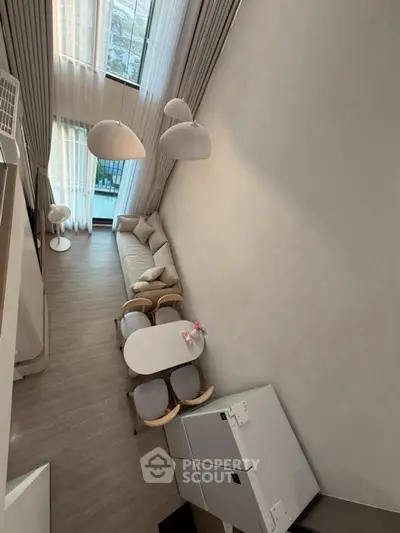 Stunning modern living room with high ceilings and elegant decor in a luxurious apartment.