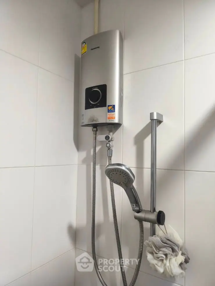 Modern bathroom with sleek shower unit and water heater