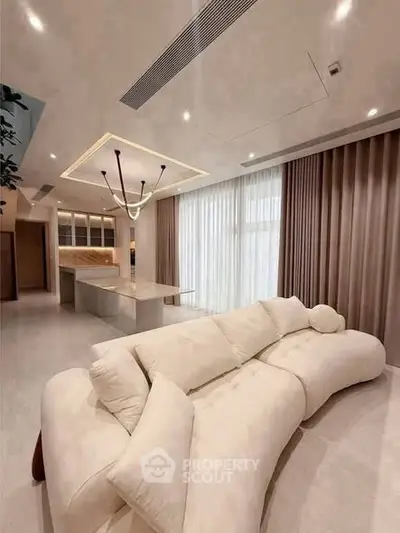 Luxurious modern living room with elegant sofa and open kitchen layout