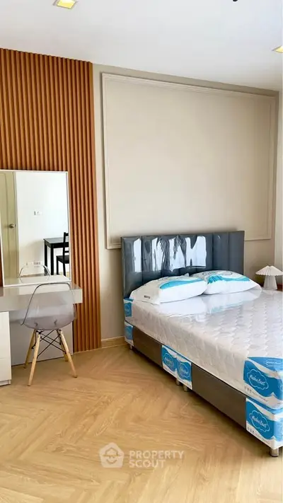 Modern bedroom with stylish decor and cozy ambiance, featuring a sleek bed and elegant wooden accents.