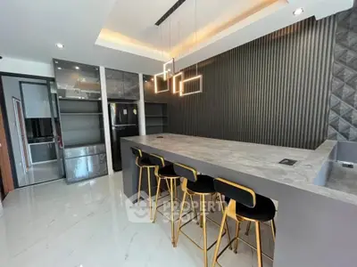 Modern kitchen with sleek island and stylish bar stools