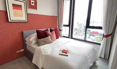 Modern bedroom with city view, featuring stylish decor and large windows for natural light.