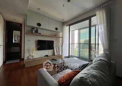 Modern living room with large balcony and city view, featuring stylish decor and cozy seating area.