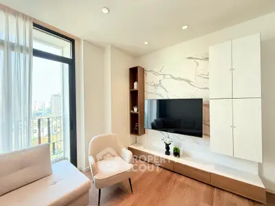 Modern living room with elegant decor and city view, featuring a sleek TV setup and cozy seating area.