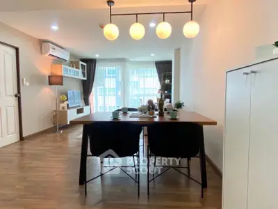 Spacious modern living room with dining area and stylish lighting in a cozy apartment.