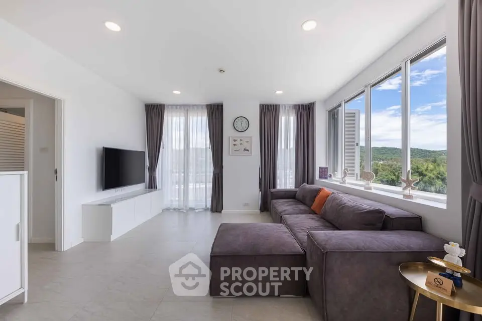 Spacious modern living room with large windows and scenic view